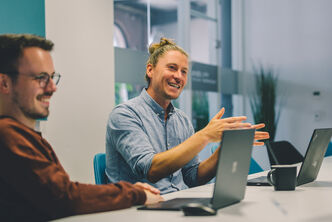An Arvato employee of the financial services department gestures in a conversation