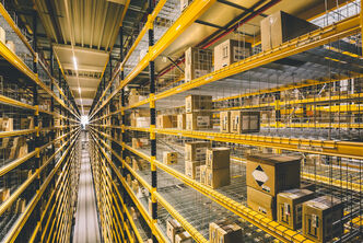 A yellow high bay warehouse with various cartons